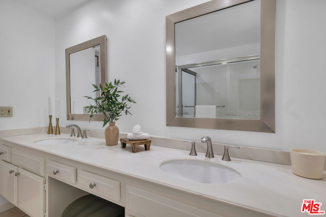 11700 Doral Avenue Porter Ranch, CA 91326 - Photo 32 of 65 a bathroom with double vanity sinks and a mirror