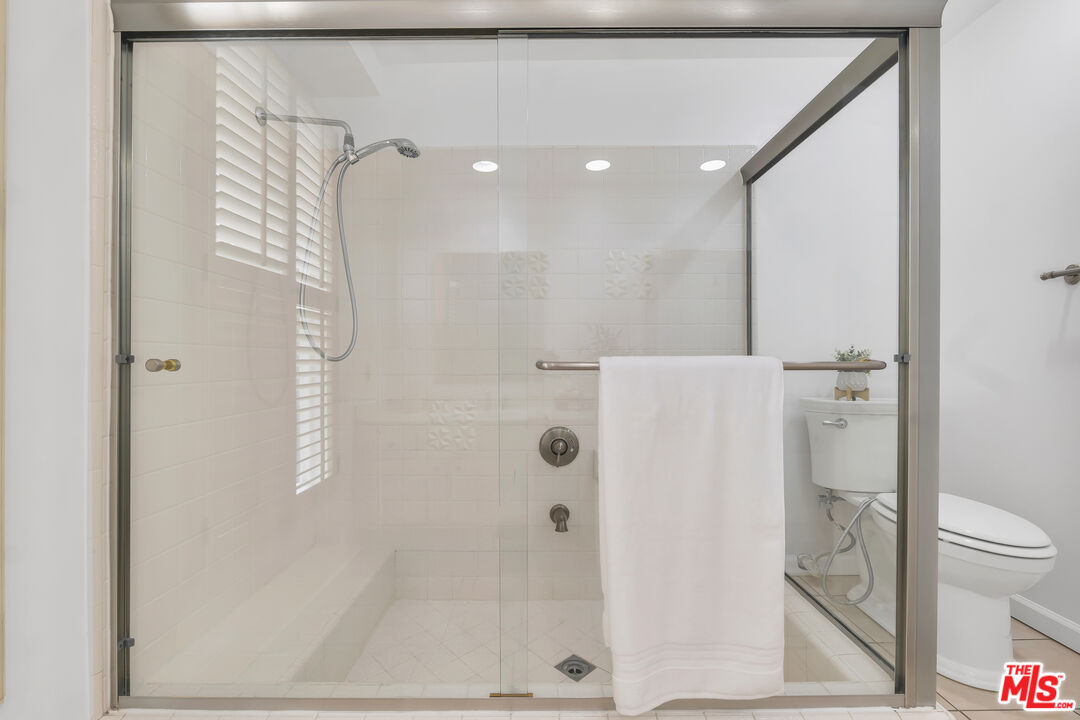 11700 Doral Avenue Porter Ranch, CA 91326 - Photo 33 of 65 a bathroom with a shower and a toilet