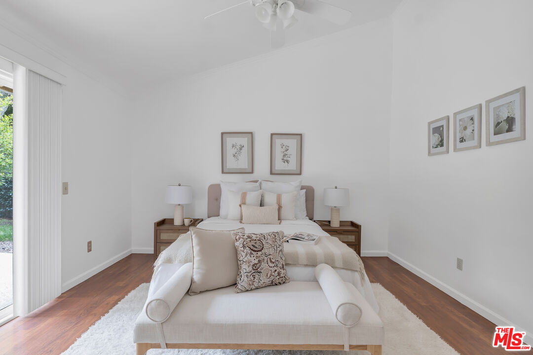 11700 Doral Avenue Porter Ranch, CA 91326 - Photo 37 of 65 a bedroom with a bed and a painting on the wall