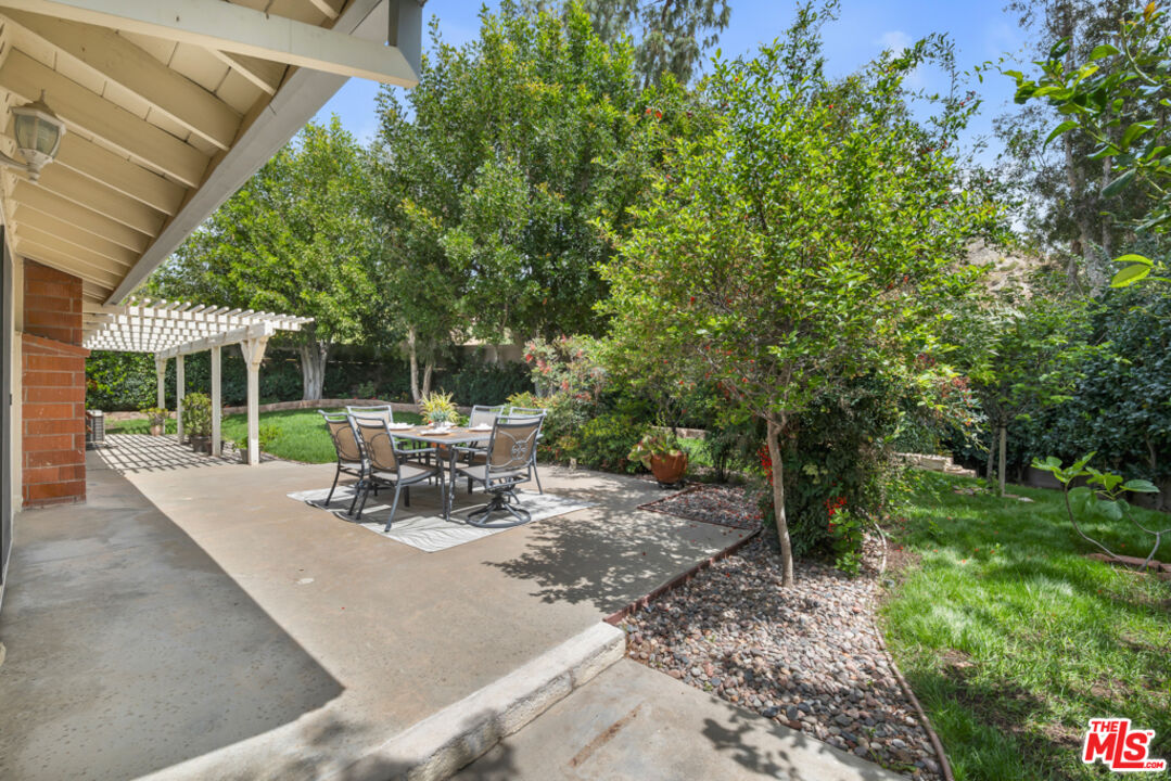 11700 Doral Avenue Porter Ranch, CA 91326 - Photo 52 of 65 a view of a patio with table and chairs and potted plants