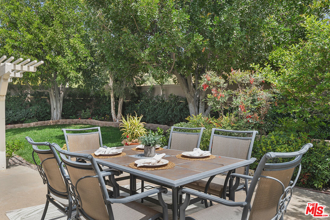 11700 Doral Avenue Porter Ranch, CA 91326 - Photo 54 of 65 a view of a dinning table and chairs in the garden