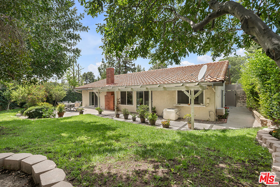 11700 Doral Avenue Porter Ranch, CA 91326 - Photo 55 of 65 a view of a house with backyard sitting area and garden