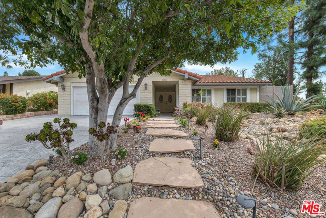 11700 Doral Avenue Porter Ranch, CA 91326 - Photo 58 of 65 a front view of a house with a garden
