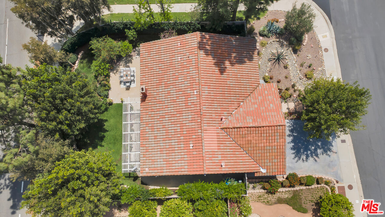 11700 Doral Avenue Porter Ranch, CA 91326 - Photo 63 of 65 a view of a house with a yard and potted plants