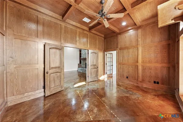 a view of a hallway with wooden shelves