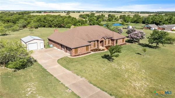 a view of a big house with a yard