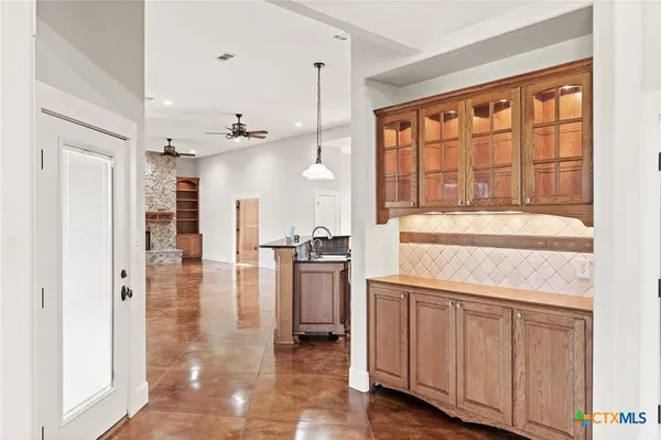 a kitchen with a refrigerator oven stove and a sink with granite countertops