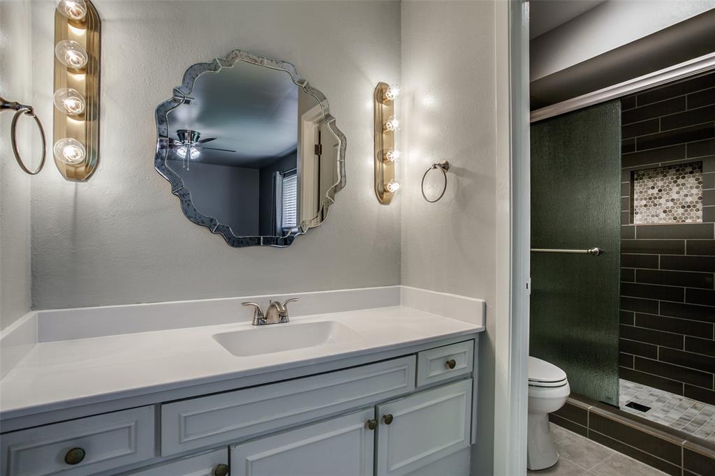 2012 Custer Parkway Richardson, TX 75080 - Photo 11 of 12 a bathroom with a toilet a sink and mirror