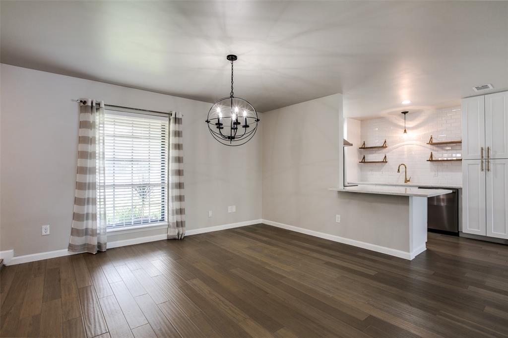 2012 Custer Parkway Richardson, TX 75080 - Photo 5 of 12 an empty room with wooden floor chandelier and windows