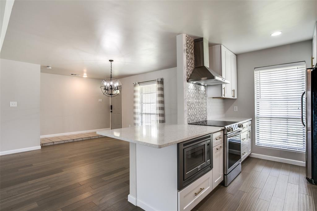 2012 Custer Parkway Richardson, TX 75080 - Photo 8 of 12 a kitchen with stainless steel appliances granite countertop a stove a sink and a refrigerator