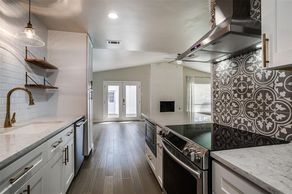 2012 Custer Parkway Richardson, TX 75080 - Photo 9 of 12 a kitchen with granite countertop a sink a counter space wooden floor and stainless steel appliances