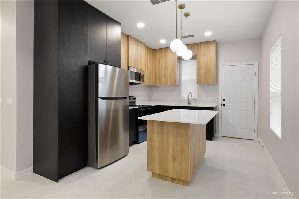 4200 Hummingbird Avenue McAllen, TX 78504 - Photo 10 of 11 a kitchen with a refrigerator a sink and a oven