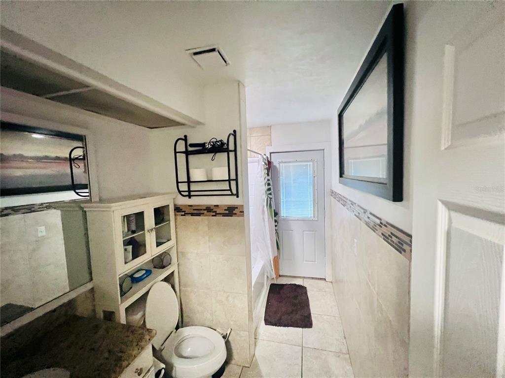 357 Tymber Run Ormond Beach, FL 32174 - Photo 18 of 32 a bathroom with a toilet a sink and a mirror