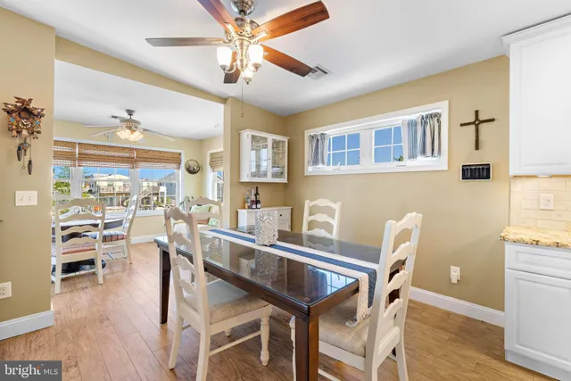 a living room with stainless steel appliances kitchen island granite countertop furniture and a dining table