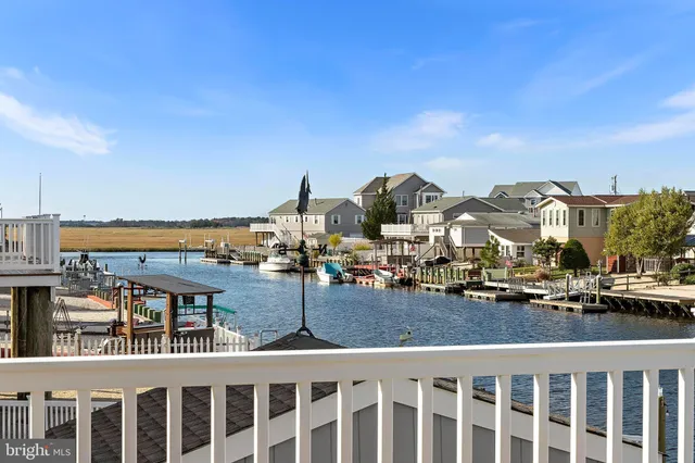 a bedroom with a bed and dresser with mirror