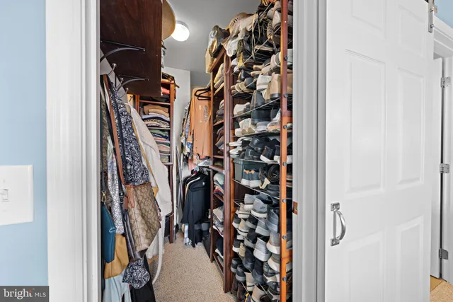 a view of a livingroom with a baby crib and dresser