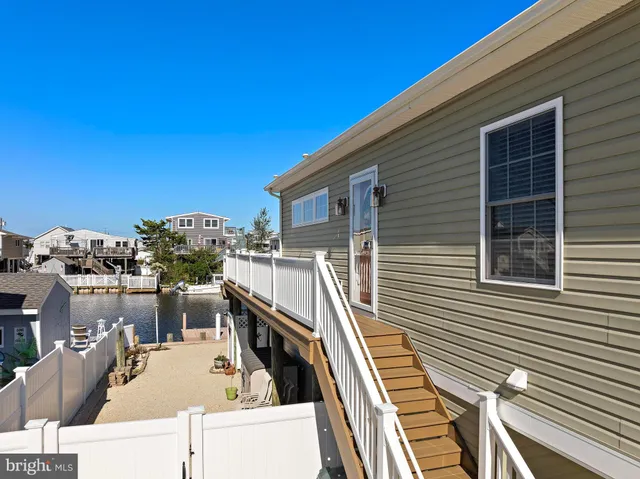 a kitchen with stainless steel appliances granite countertop a stove refrigerator and white cabinets