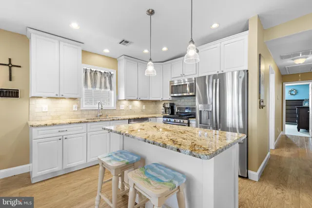 a living room with fireplace furniture and a wooden floor