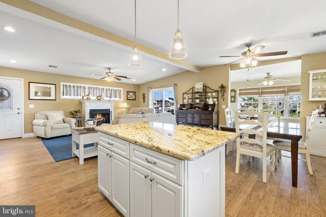 a living room with stainless steel appliances furniture and a flat screen tv