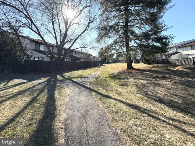 a view of yard covered with snow in front of house