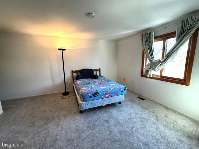 a bedroom with a bed and window