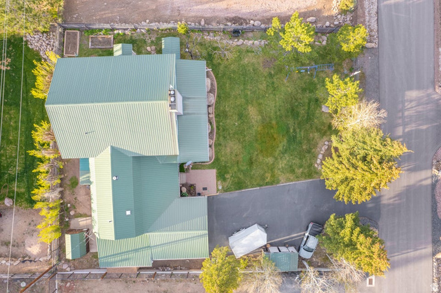 48 South Sage Road Pine Valley, UT 84781 - Photo 10 of 61 Property featuring a green metal roof, a paved driveway, and a manicured lawn