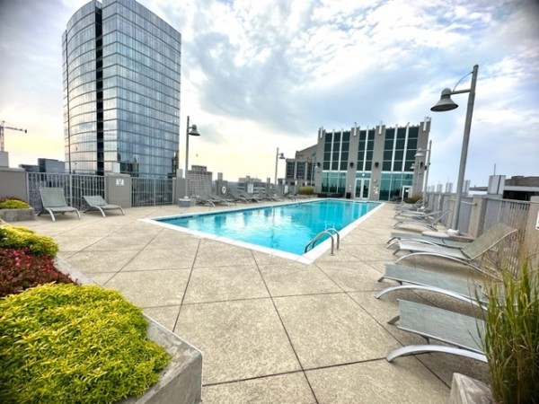a view of swimming pool with outdoor seating and plants