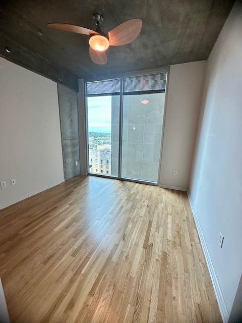 415 Church Street, Unit 1603 Nashville, TN 37219 - Photo 8 of 14 a view of an empty room with wooden floor and windows