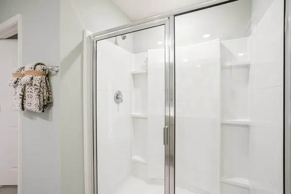 a bathroom with a glass shower door