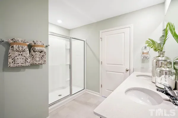 a view of a livingroom with wooden floor and a bedroom