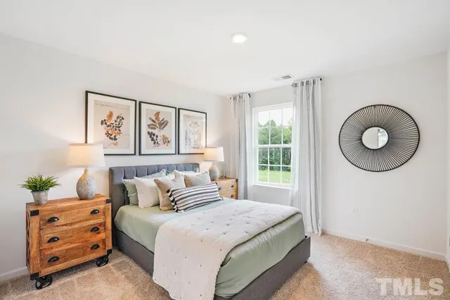 a bedroom with a bed and a couch