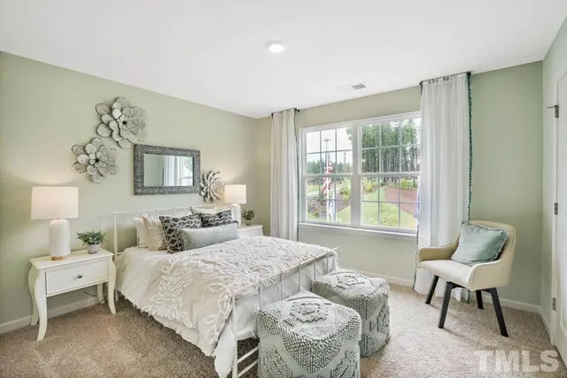 a bedroom with a bed and a painting on the wall