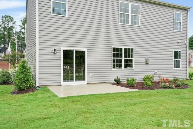 a front view of a house with a yard and porch