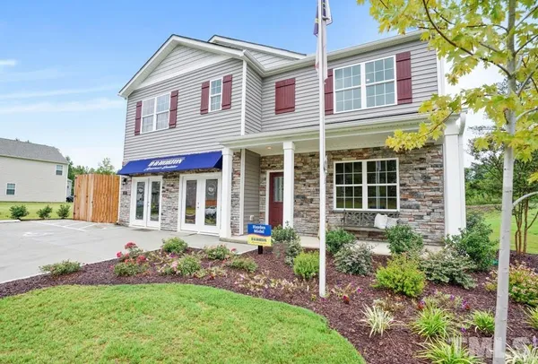 a front view of house with yard and green space