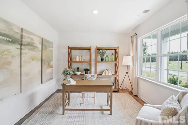 a dining room with furniture and window