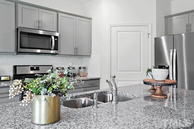 a kitchen with a potted plant on the counter and cabinets