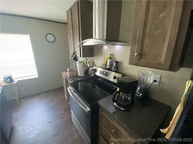 a kitchen with a stove and a window