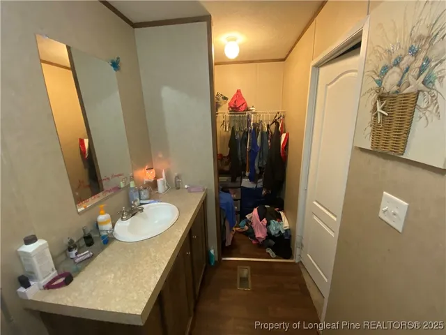 a bathroom with a sink mirror and vanity