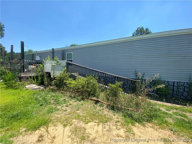 a backyard of a house with plants and outdoor seating