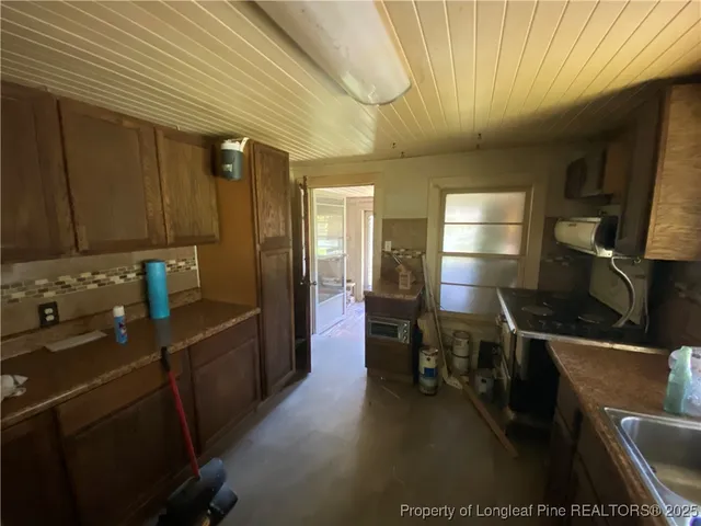 a kitchen with a sink appliances and cabinets