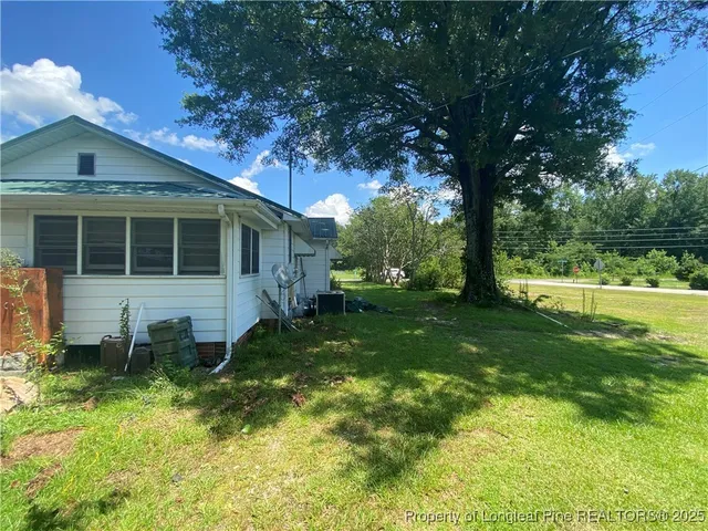 a view of house with backyard