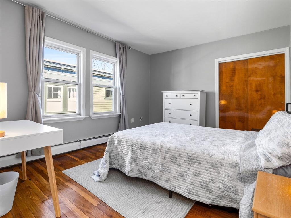 91-93 Rossmore Road, Unit 3 Boston, MA 02130 - Photo 13 of 25 a bedroom with a bed and wooden floor