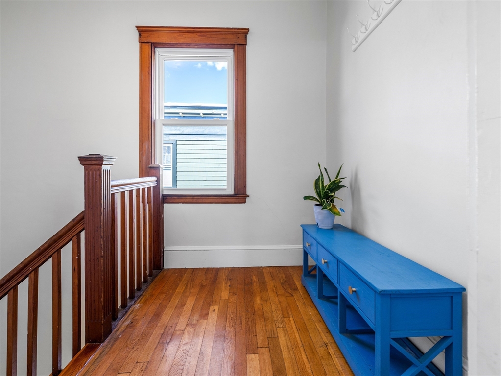 91-93 Rossmore Road, Unit 3 Boston, MA 02130 - Photo 2 of 25 a view of hallway with a window and wooden floor