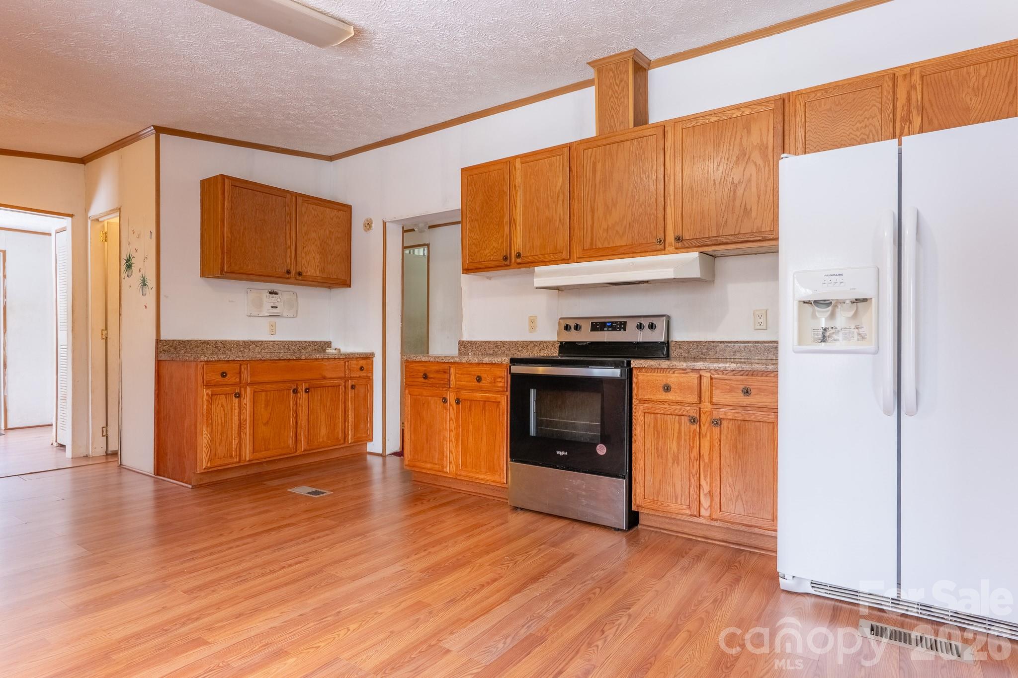 8636 County Line Road Hickory, NC 28602 - Photo 6 of 18 a kitchen with stainless steel appliances a stove top oven a sink and a refrigerator