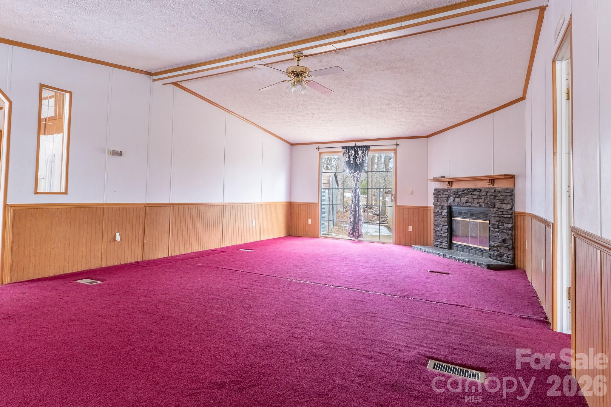 8636 County Line Road Hickory, NC 28602 - Photo 9 of 18 a view of empty room with a fireplace and wooden floor