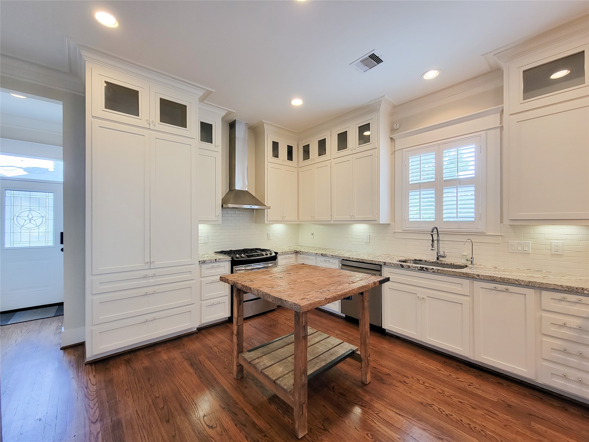 1140 West Cottage Street Houston, TX 77009 - Photo 17 of 37 a kitchen with a sink cabinets and wooden floor