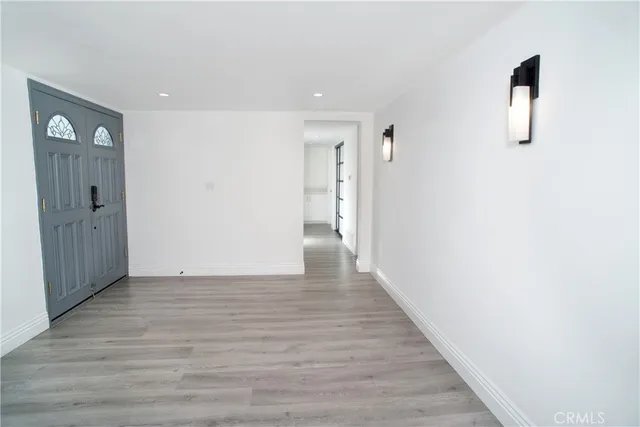 a view of a hallway with wooden floor