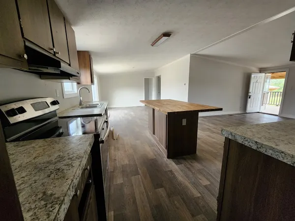 a kitchen with a stove and a refrigerator