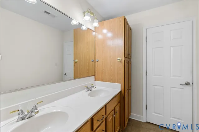 a bathroom with a sink double vanity and a mirror