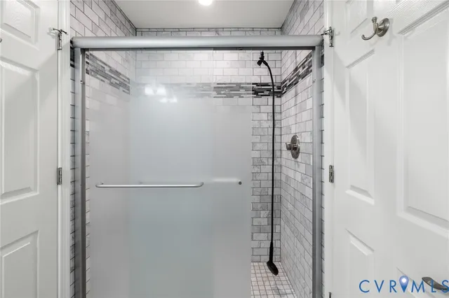 a bathroom with a glass shower door